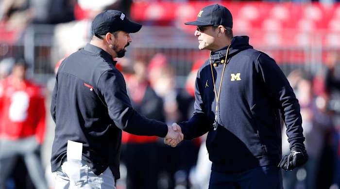 Michigan Wolverines head coach Jim Harbaugh and Ohio State Buckeyes head coach Ryan Day shake hands.